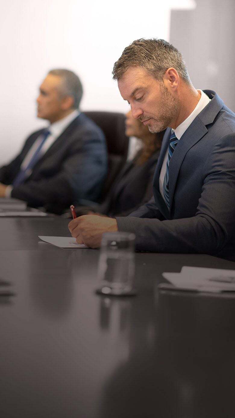 Executive in a boardroom meeting, representing succession planning and leadership pipeline development.