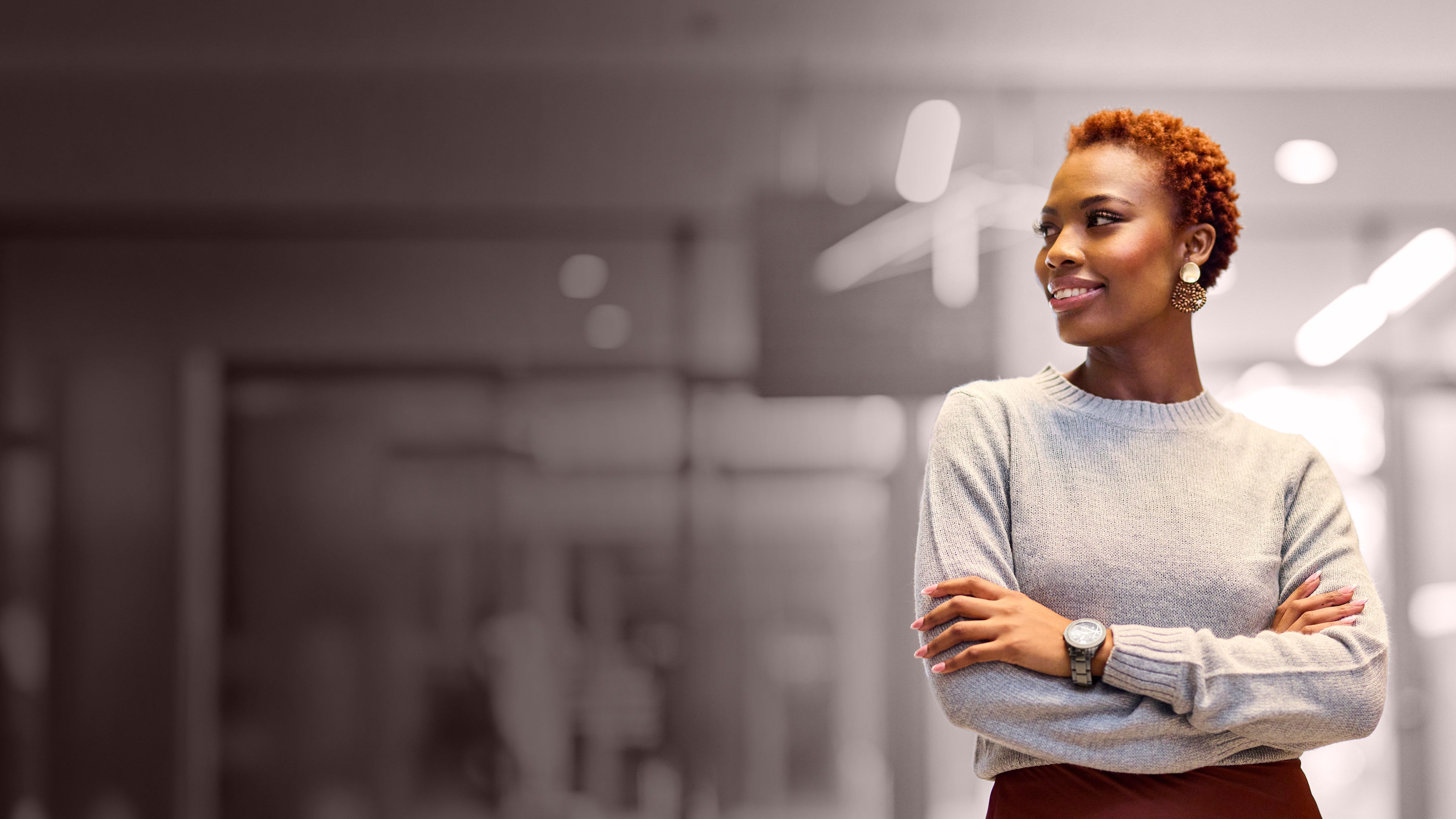 Confident professional standing in an office, representing leadership growth, readiness, and executive development.