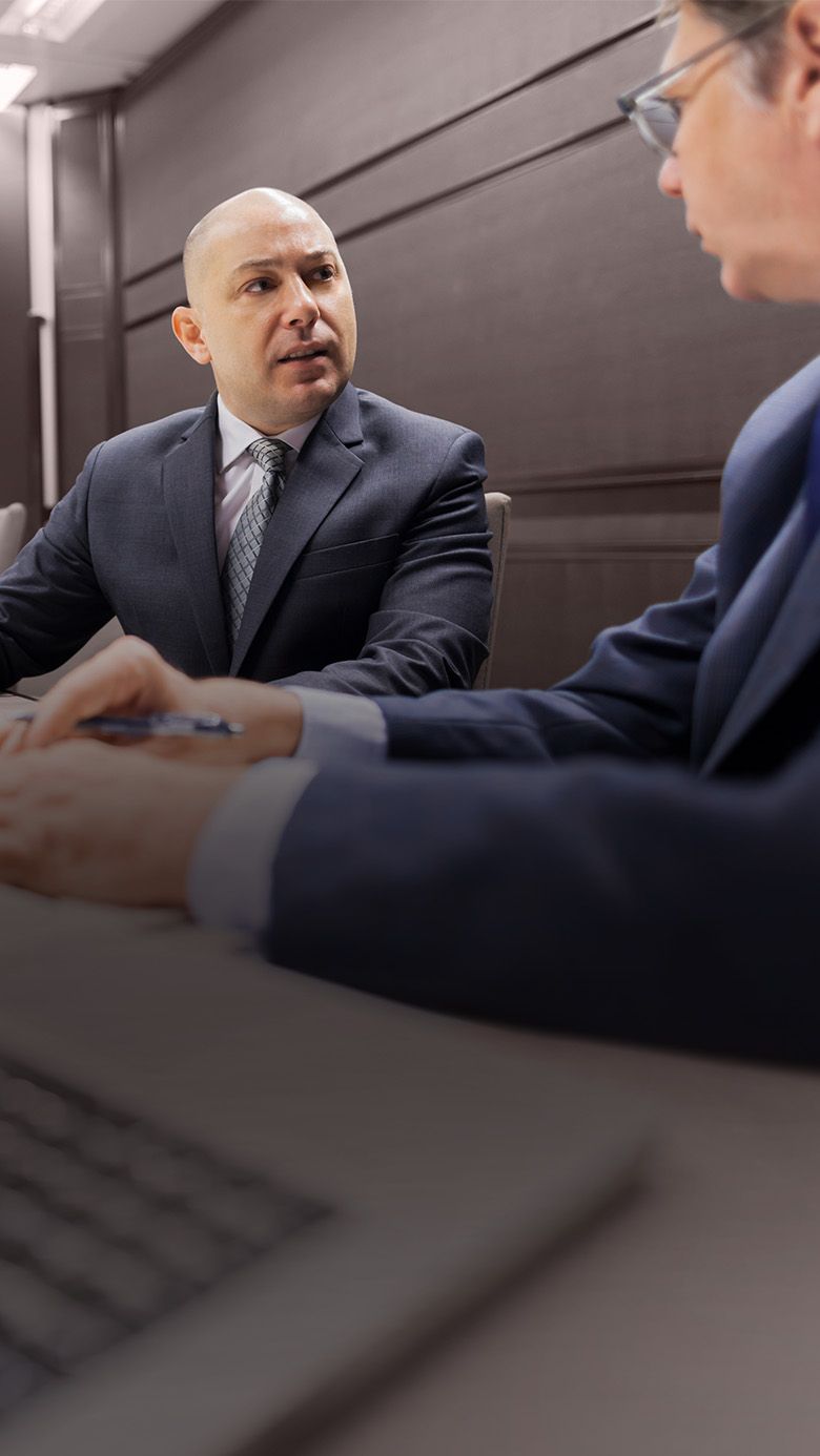 CEO in a boardroom conversation, representing private equity leadership pressure, decision-making, and executive adaptability.
