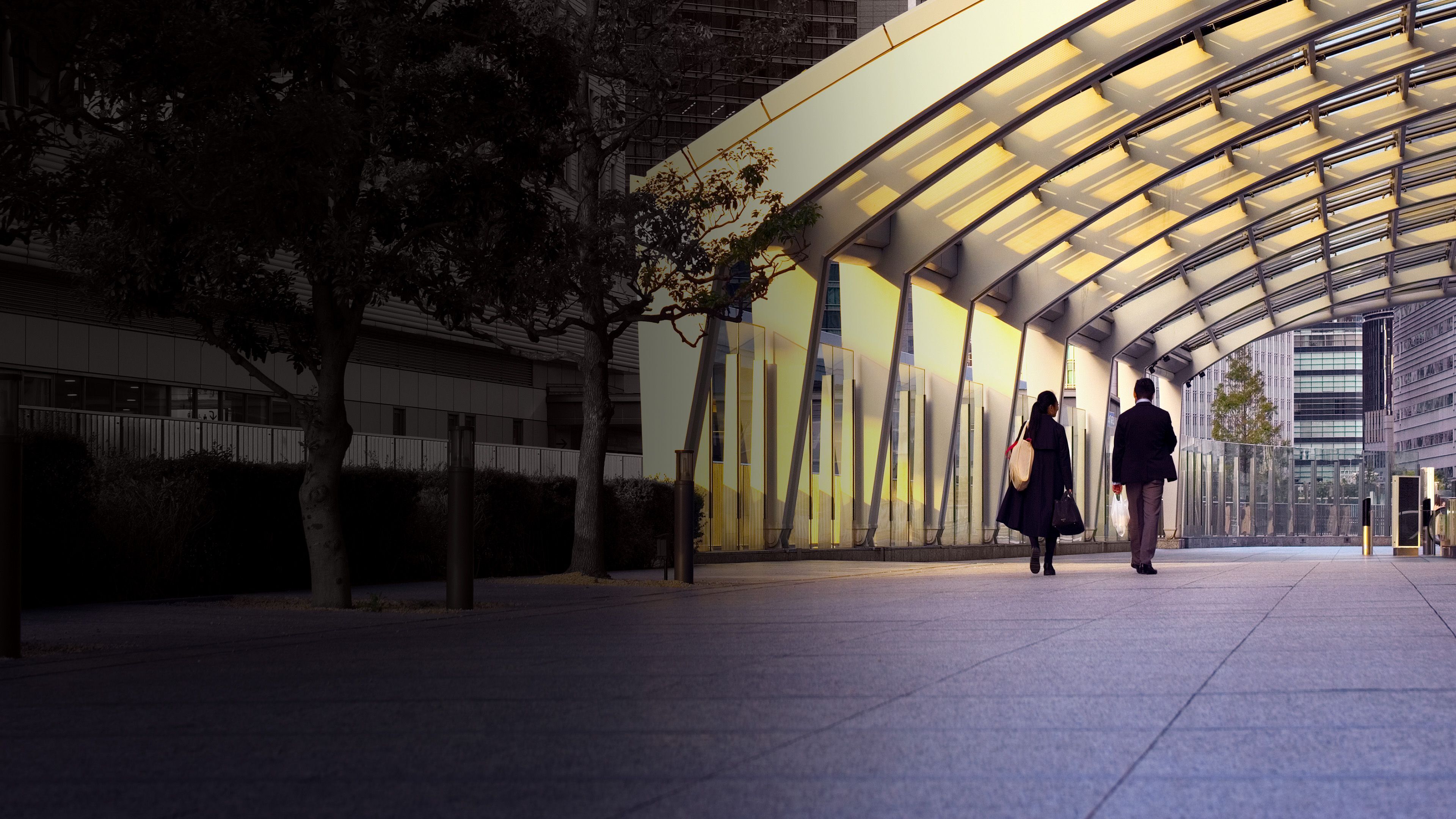 Business leaders walking through a modern corridor, representing a structured path for advancing succession planning maturity.