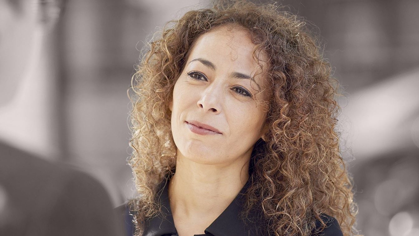 Image for RHR’s About Us and Careers section featuring a professional woman engaged in conversation, representing how RHR invests in its people through connection, development, support, and leadership growth.