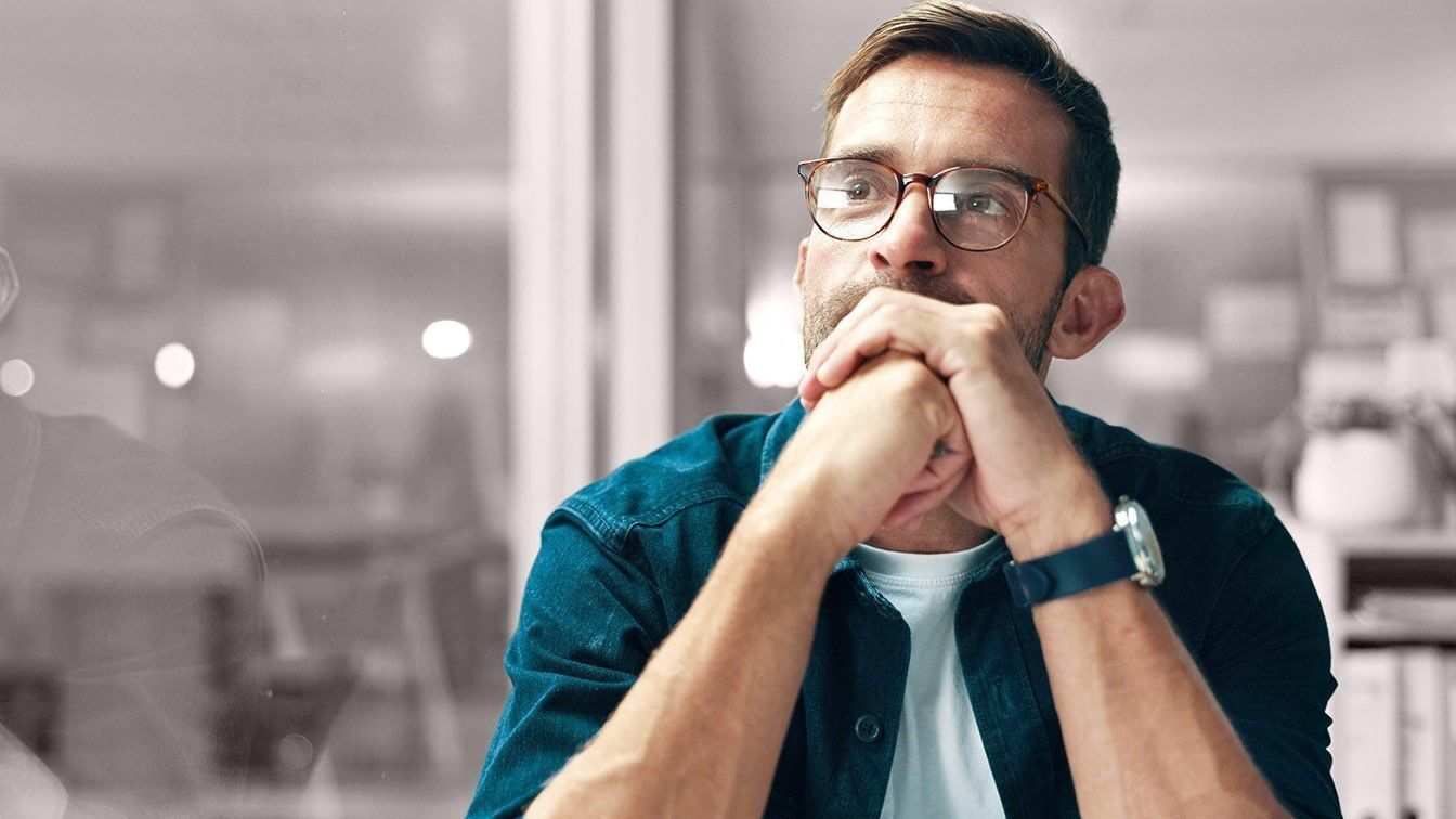 RHR International's legacy of leadership assessment and development is reflected in this image of a professional in thoughtful reflection, representing the firm's long-standing focus on helping leaders navigate complex business challenges and growth opportunities.
