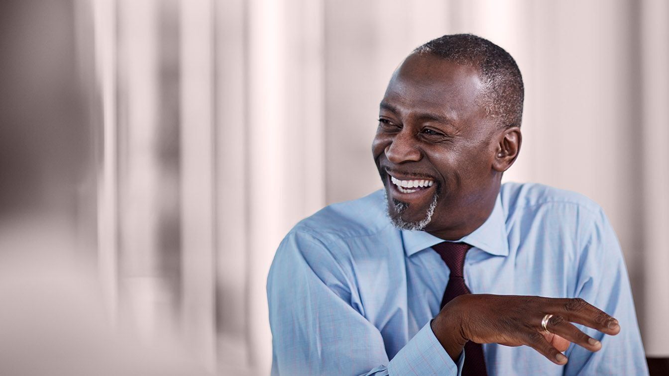 Professional engaged in conversation, reflecting RHR International’s value of Enduring Impact through meaningful leadership dialogue, trusted partnership, and a focus on creating lasting organizational success.