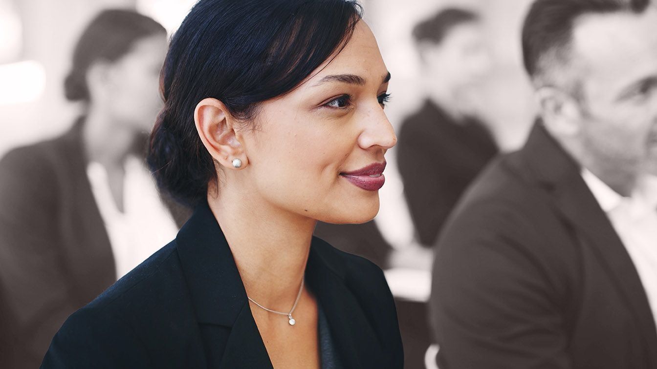 Professional attentively engaged in a leadership discussion, reflecting RHR International’s Pursuit of Excellence through continuous learning, thoughtful judgment, and a commitment to achieving the highest standards.