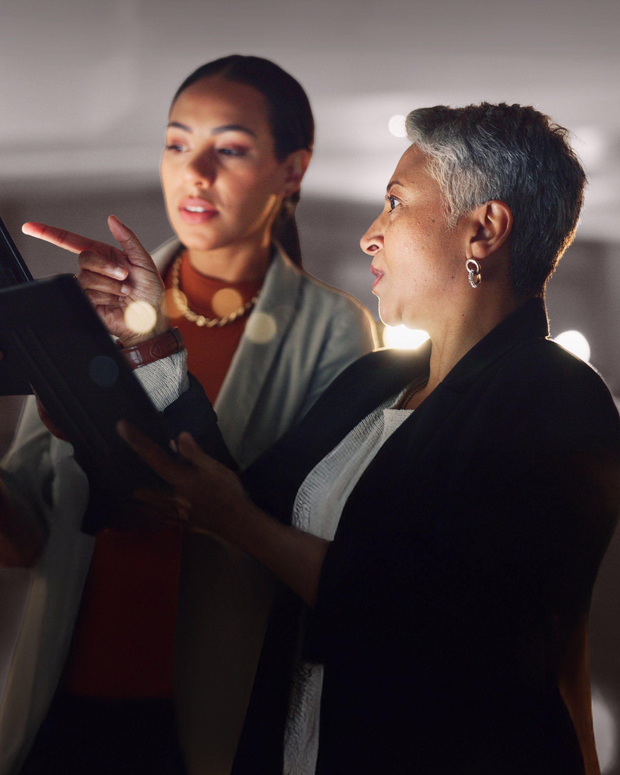 Two professionals reviewing information together, illustrating RHR’s coaching and development approach by combining guidance, insight, and real-time collaboration to help leaders strengthen capabilities and achieve their potential.