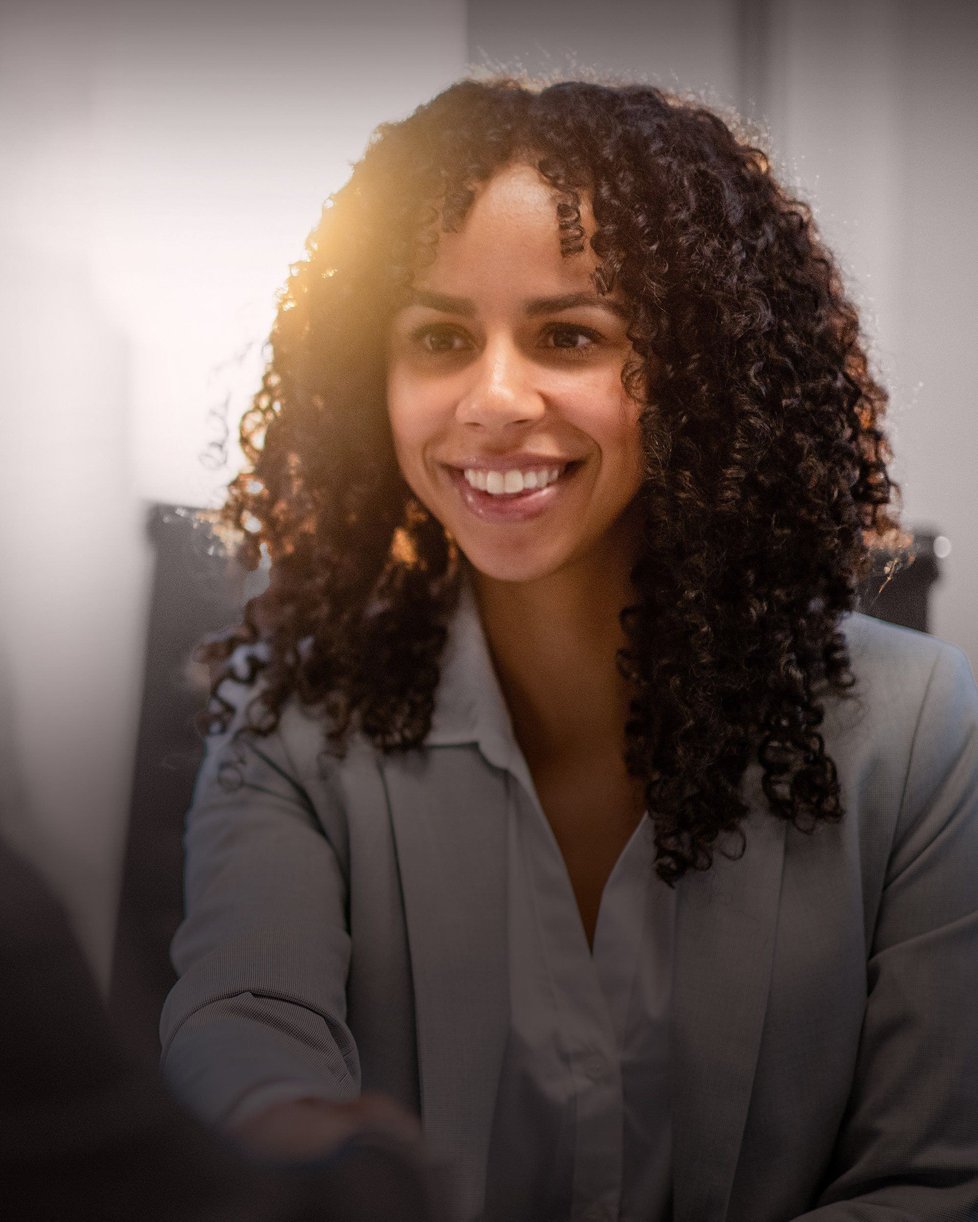 Professional extending a welcoming handshake, illustrating RHR’s selection and onboarding solutions by helping organizations identify, integrate, and accelerate the success of leaders in critical roles.