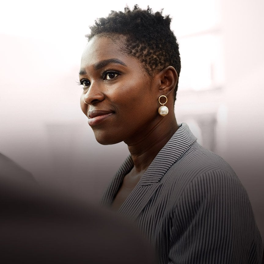 Image of a professional businesswoman in a corporate setting, representing leadership, confidence, strategic thinking, and executive presence in private equity and business environments.
