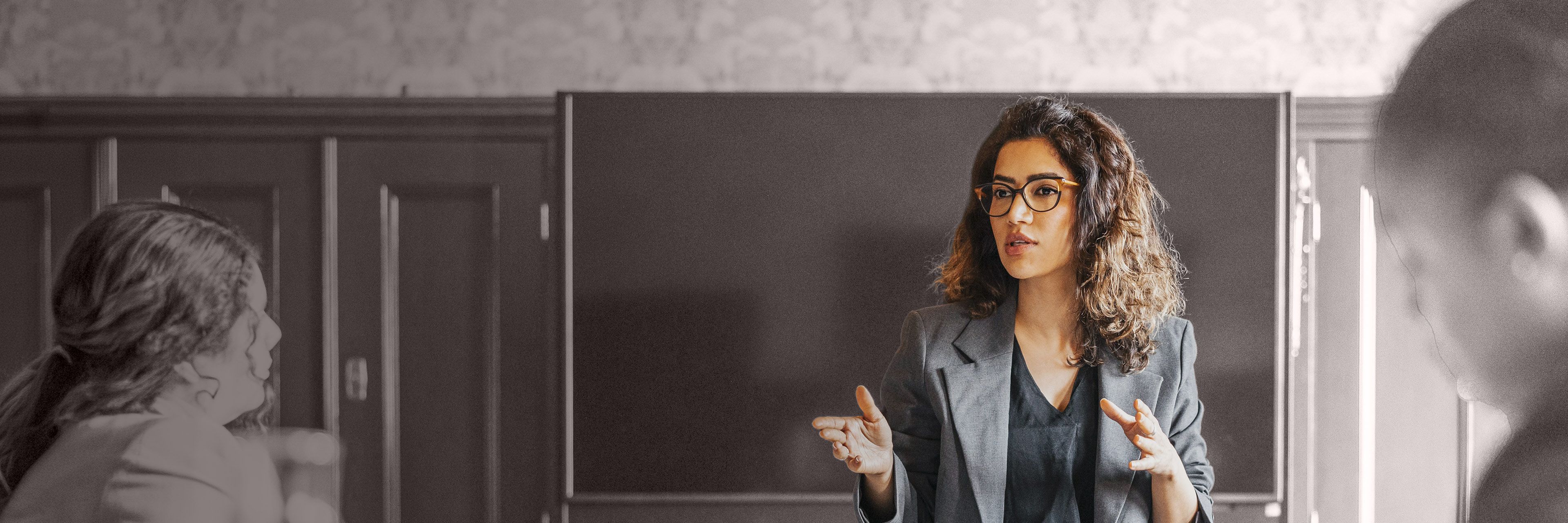 Executive speaking during a leadership meeting, representing strategic communication, collaboration, and executive decision-making.