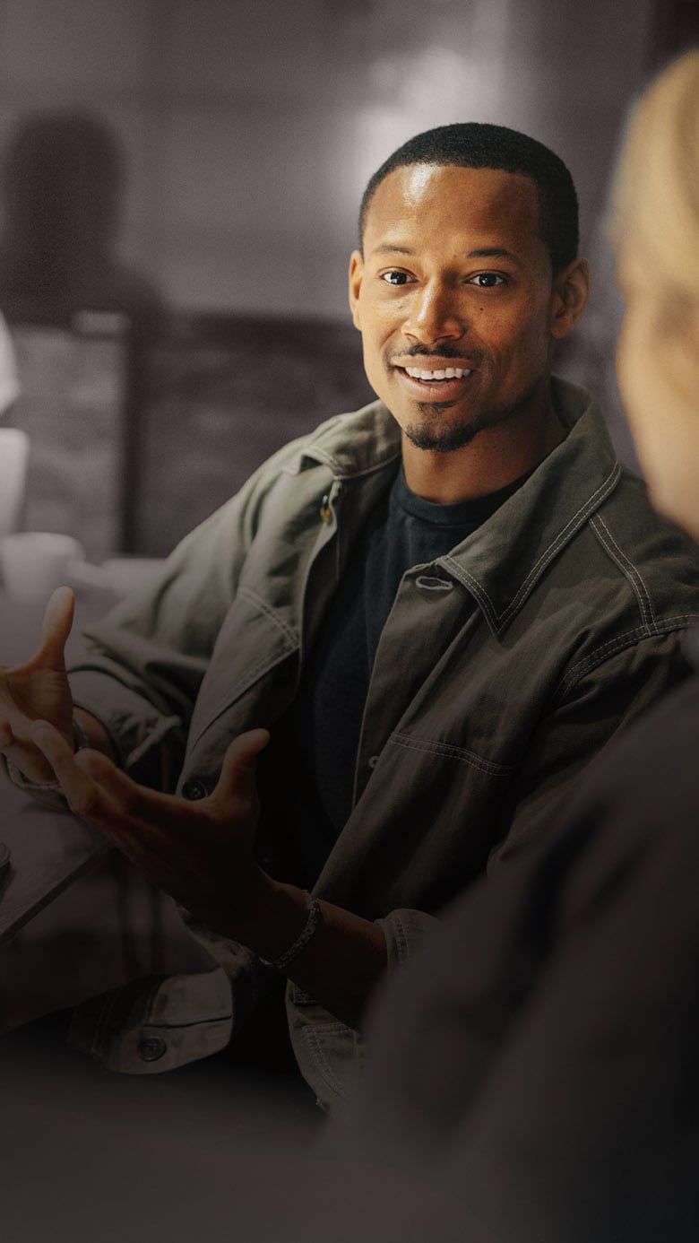 Professional speaking during a business meeting, representing collaboration, leadership communication, and team engagement.