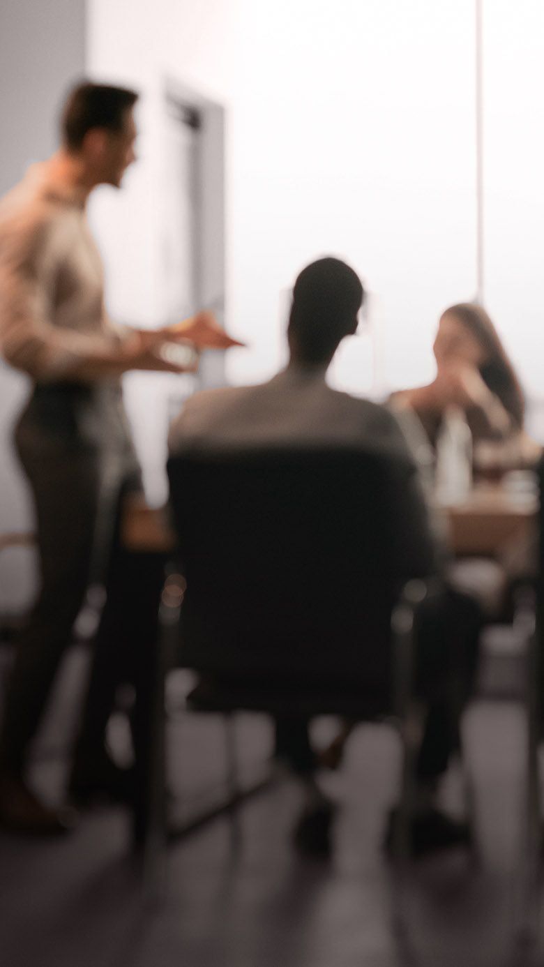 Business professionals participating in a team meeting, representing leadership collaboration, strategic discussion, and organizational alignment.