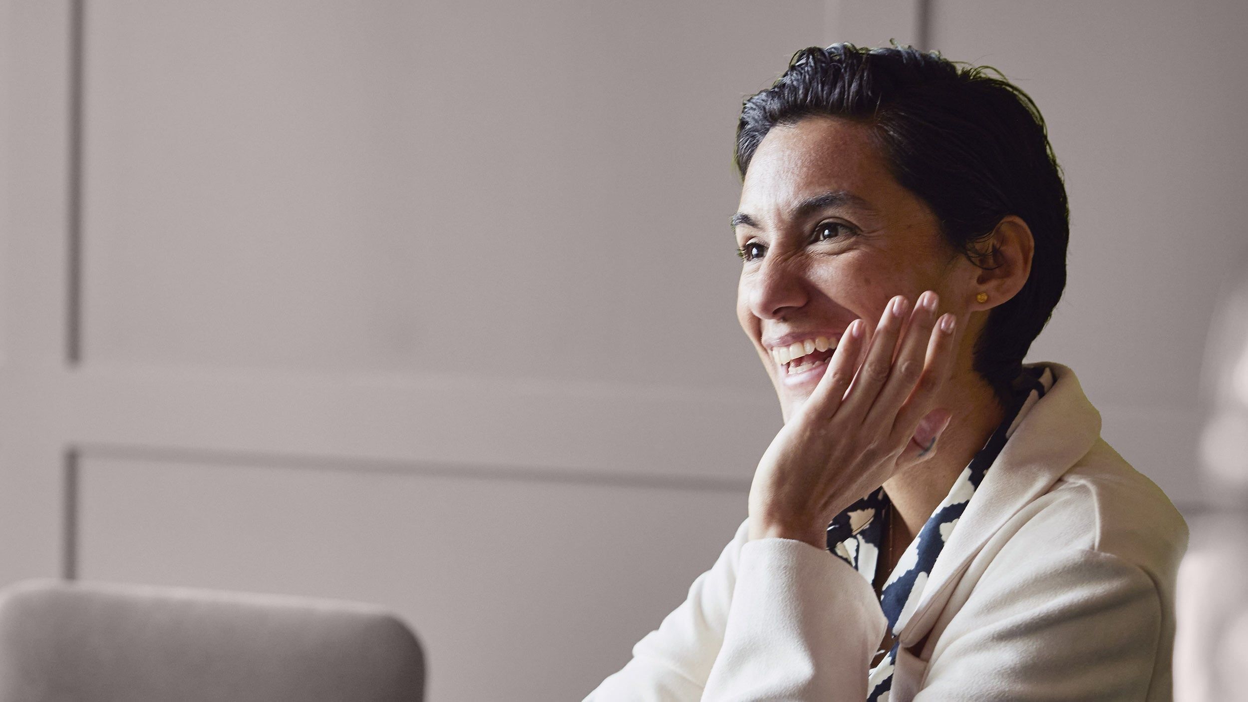 Executive smiling during a meeting, representing positive leadership, engagement, and collaborative workplace culture.