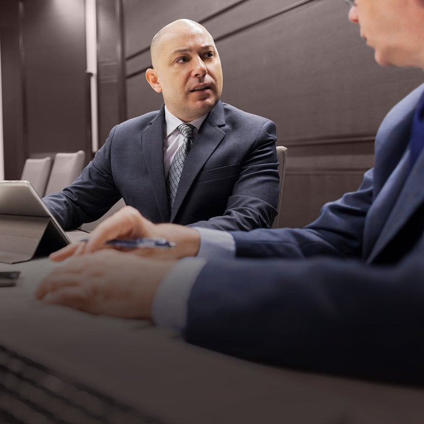 CEO in a boardroom discussion, representing private equity leadership traps, decision-making, and the shift from operator to scalable CEO.