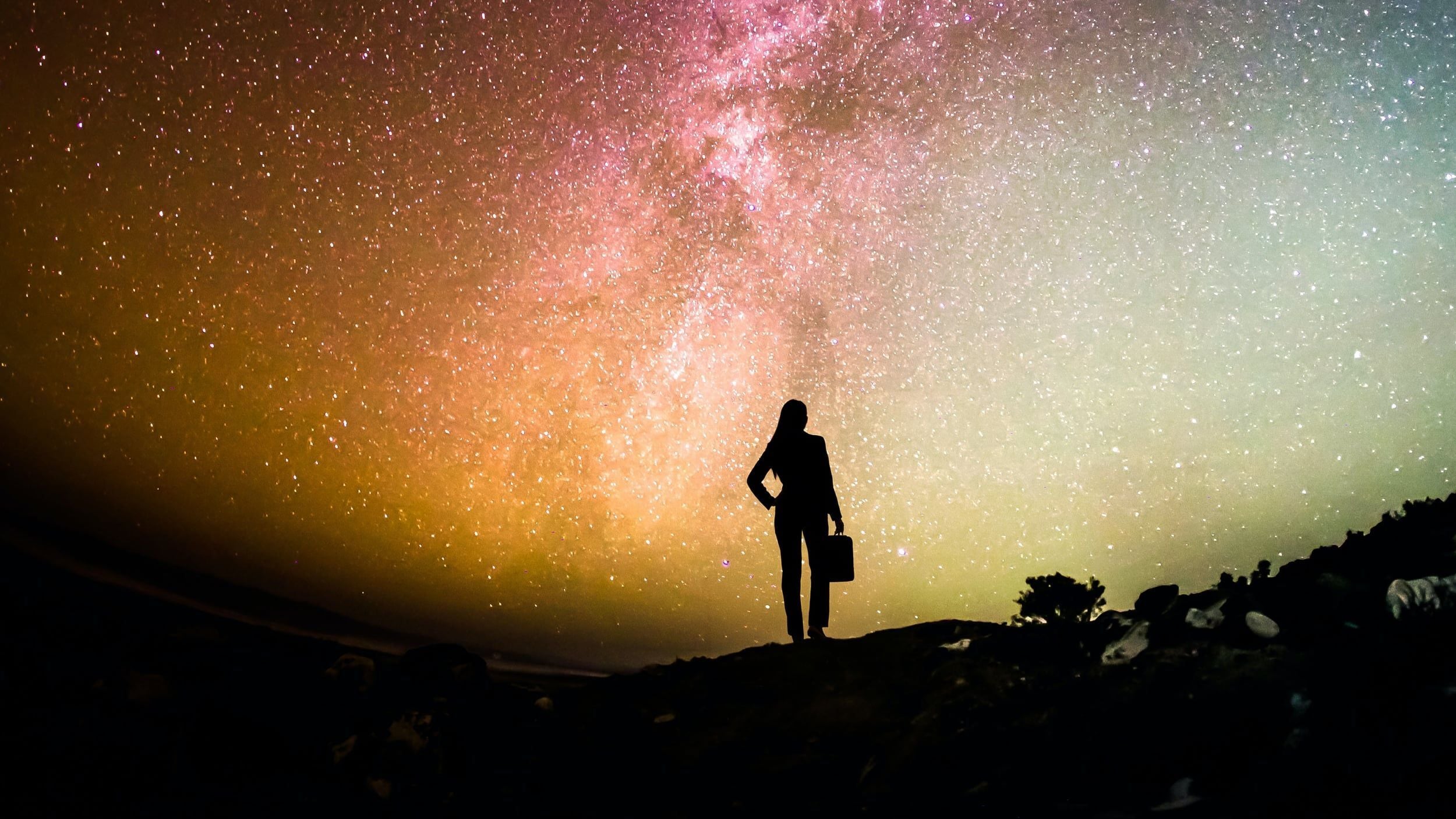 Conceptual background of a leader standing before a starry galaxy for RHR's succession planning webinar.