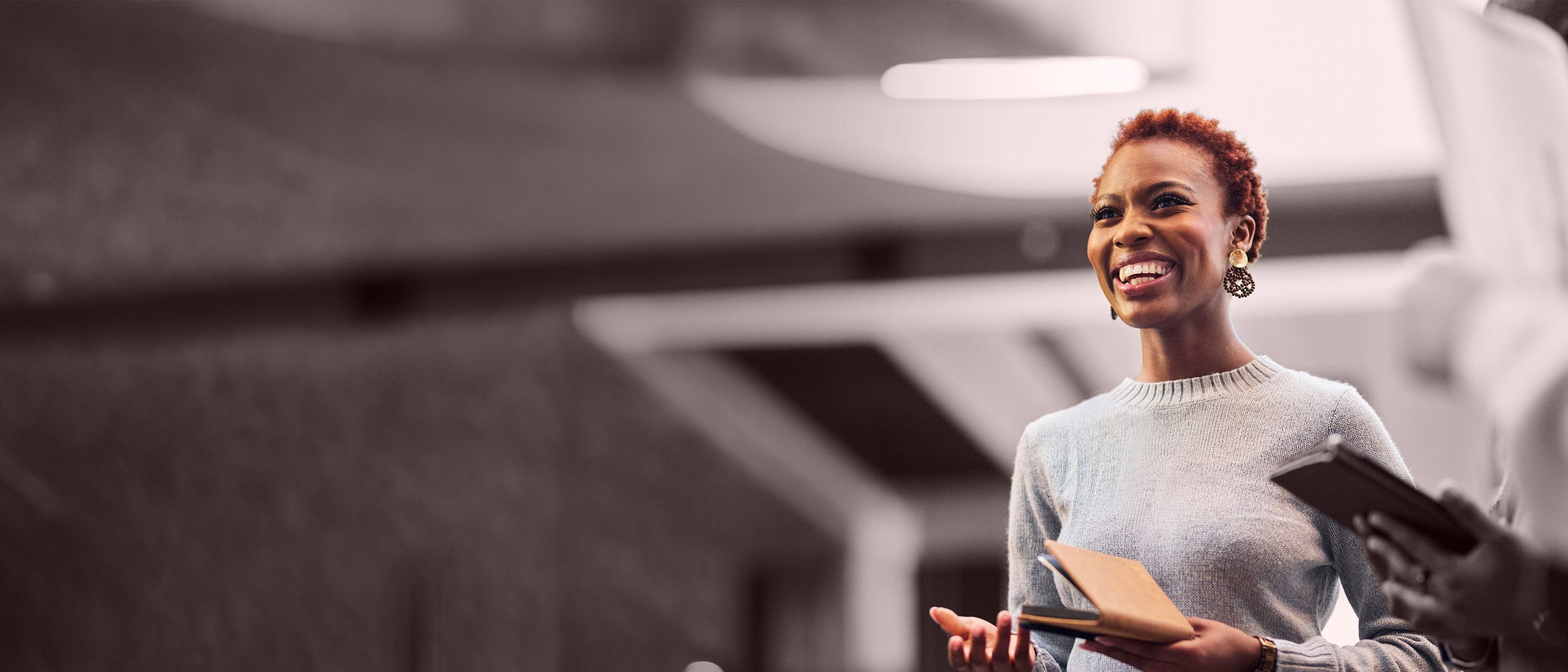 Wide banner image of a professional businesswoman speaking during a meeting, representing executive communication, leadership presence, and RHR’s CEO and board evaluation services.