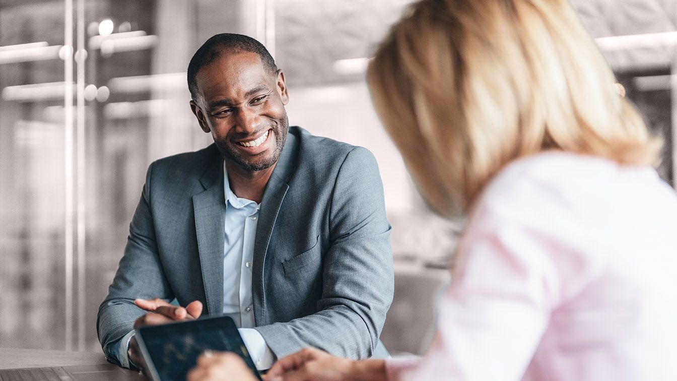 Image of business executives collaborating in a meeting, representing leadership discussion, board effectiveness, and RHR’s CEO and board evaluation services.