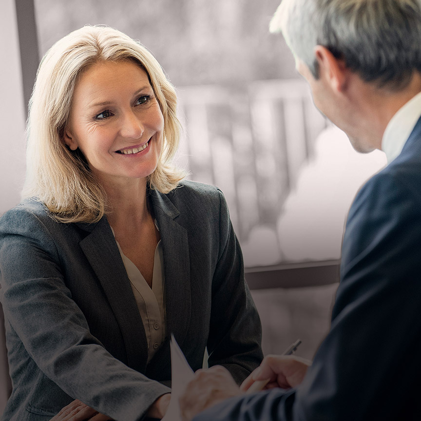 Executive assessment image of a senior leader in conversation, representing data-led insight into leadership capability, readiness, and performance.