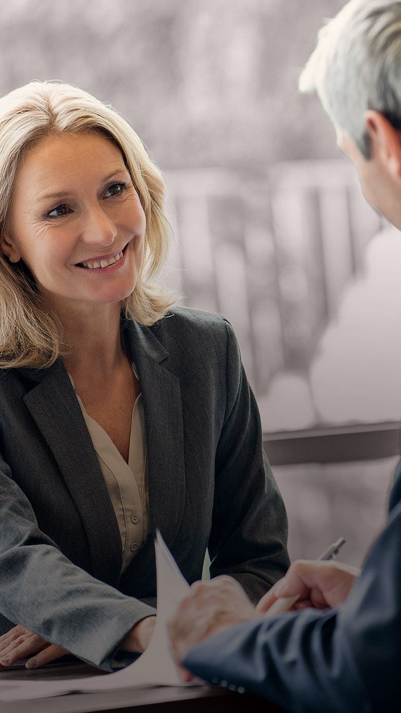 Image of business executives in discussion, representing leadership evaluation, executive decision-making, and RHR’s Executive Assessment Solutions.