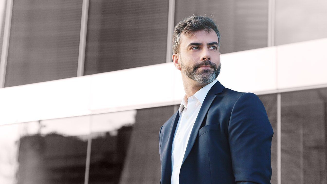 Image of a professional business executive in a corporate setting, representing leadership presence, governance, and RHR’s Board Evaluation and Development Solutions.
