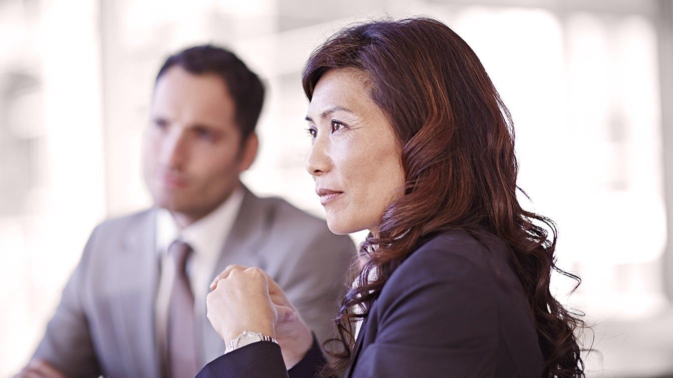Image of business executives in discussion during a meeting, representing strategic leadership, governance, and RHR’s CEO and Board Advisory services.