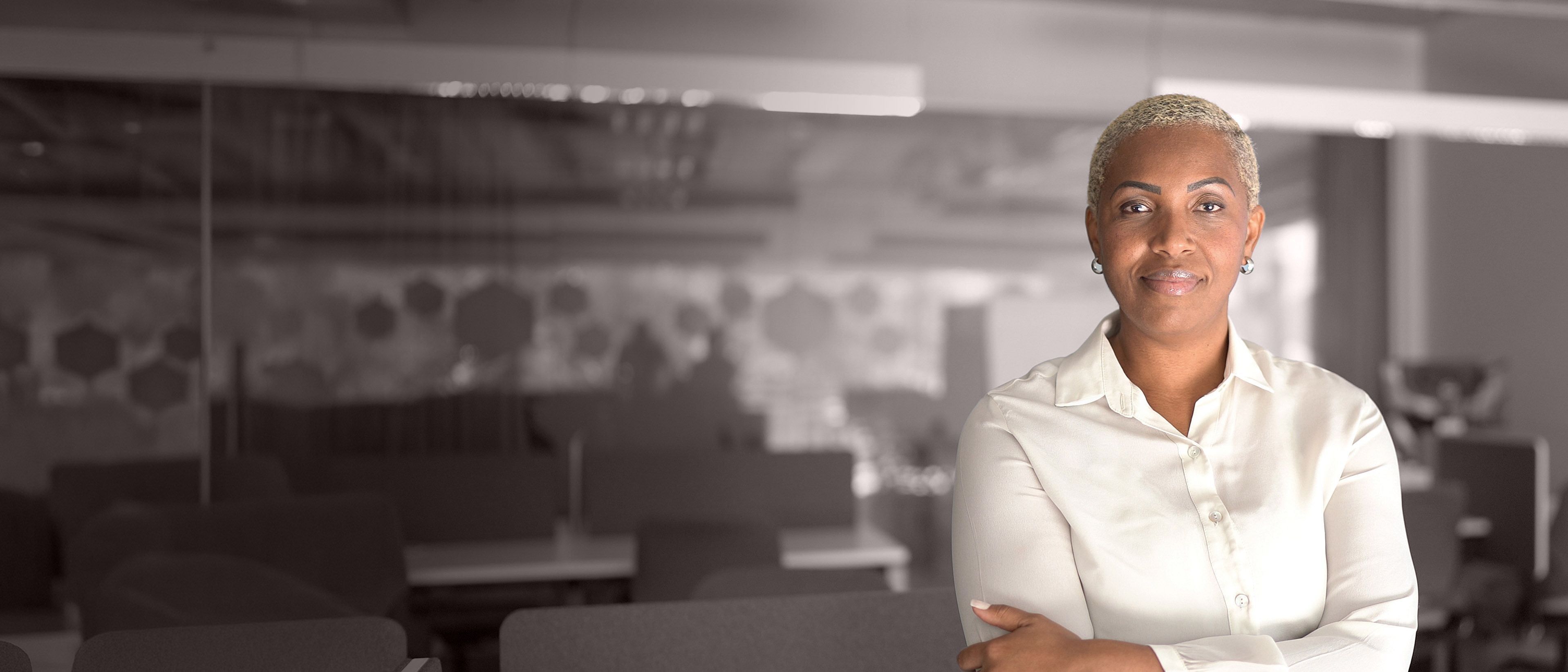 Wide banner image of a professional businesswoman in a corporate setting, representing executive onboarding, leadership transition, and RHR’s CEO Transition services.