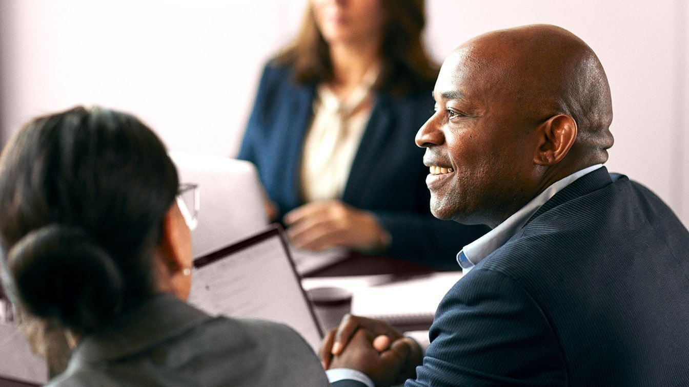 Image of business executives collaborating during a meeting, representing executive integration, leadership alignment, and RHR’s CEO Transition services.