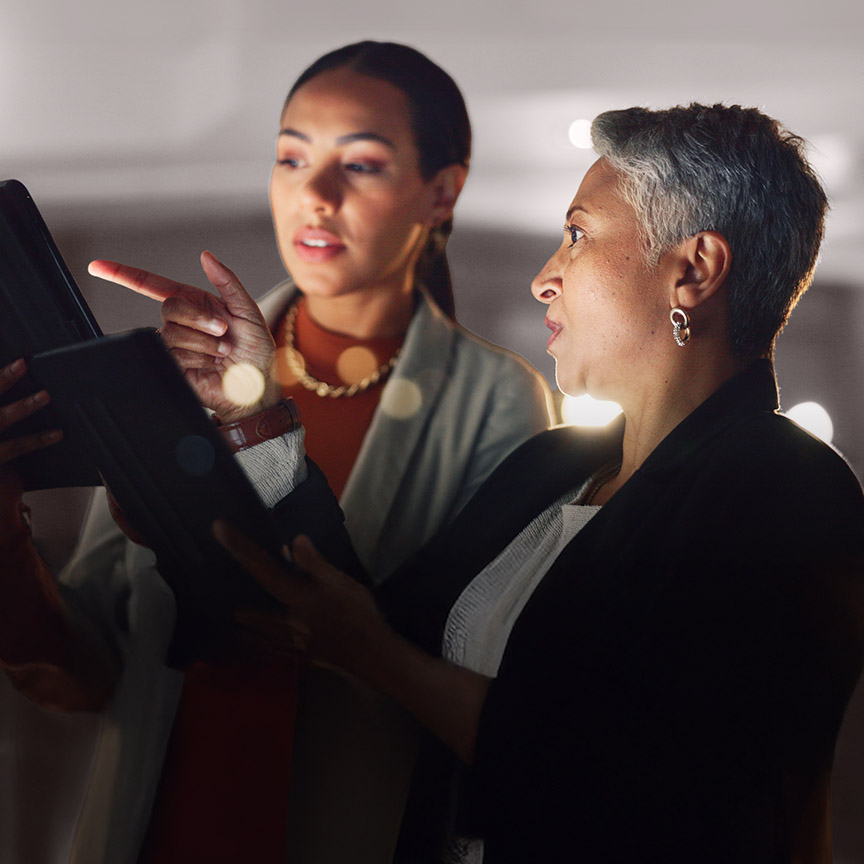 Coaching and Development image of two leaders reviewing information together, representing executive coaching, leadership growth, and performance development.