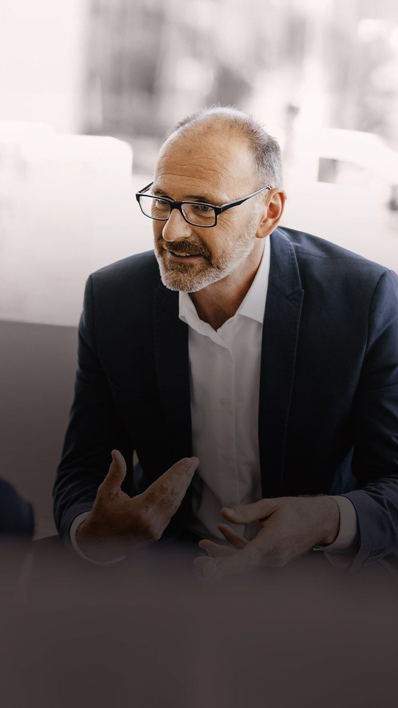 Portrait image of a business professional in a coaching discussion, representing leadership development, executive growth, and RHR’s Executive Coaching services.