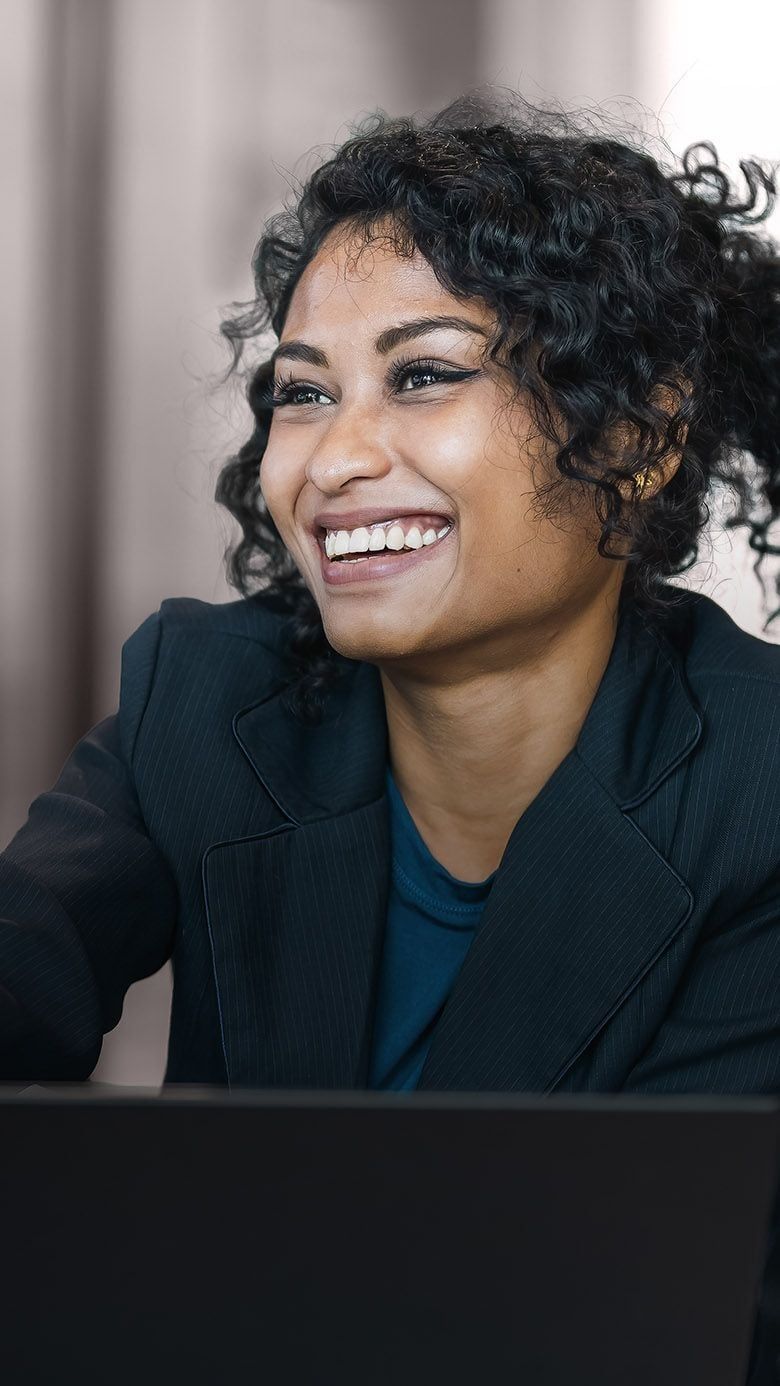 Portrait image of a business professional greeting a candidate during a meeting, representing executive hiring, leadership selection, and RHR’s External Selection Solutions.