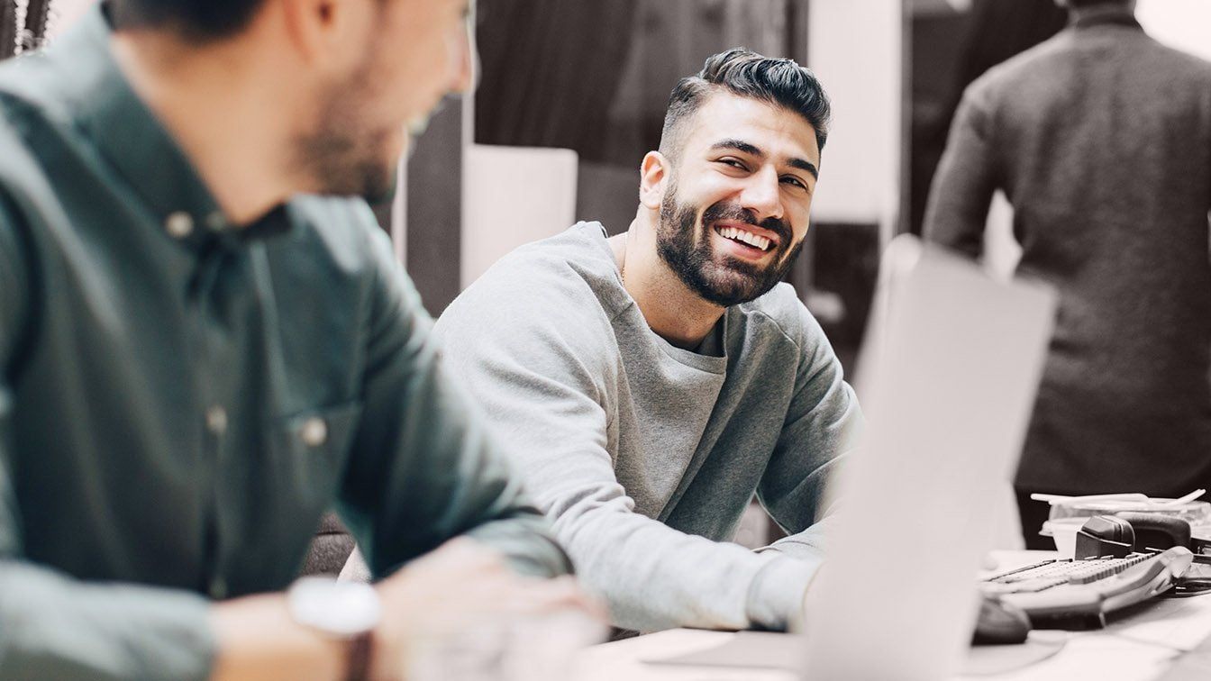 Image of business professionals collaborating in a workplace setting, representing employee engagement, workforce insights, and RHR’s People Analytics Solutions.