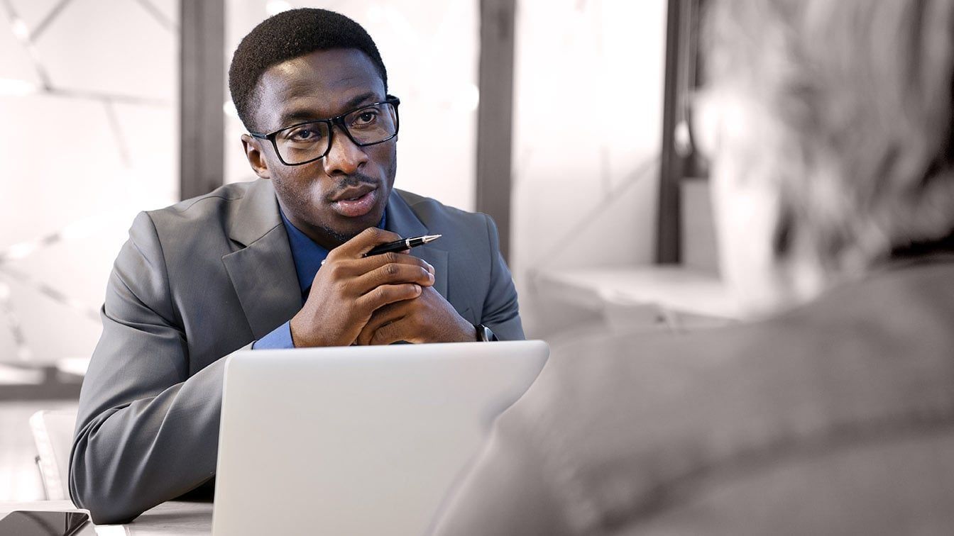 Image of a business professional in discussion during a leadership meeting, representing executive evaluation, coaching conversations, and RHR’s Strategic Assessment and Coaching Solutions.