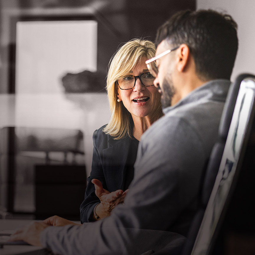 Developing talent image of two business leaders in conversation, representing leadership development, succession planning, and preparing future leaders for growth.