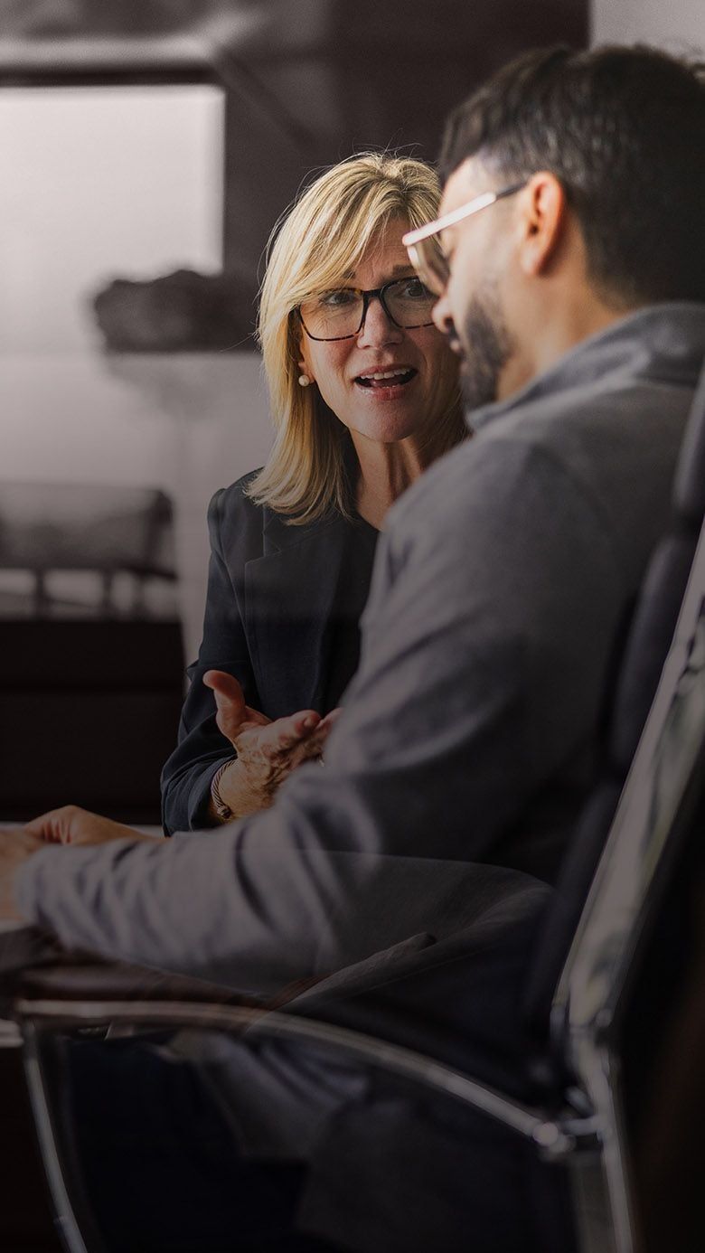 Portrait image of business professionals in a leadership discussion, representing succession readiness, leadership development, and talent pipeline growth through RHR’s Succession Planning and Developing Talent Solutions.