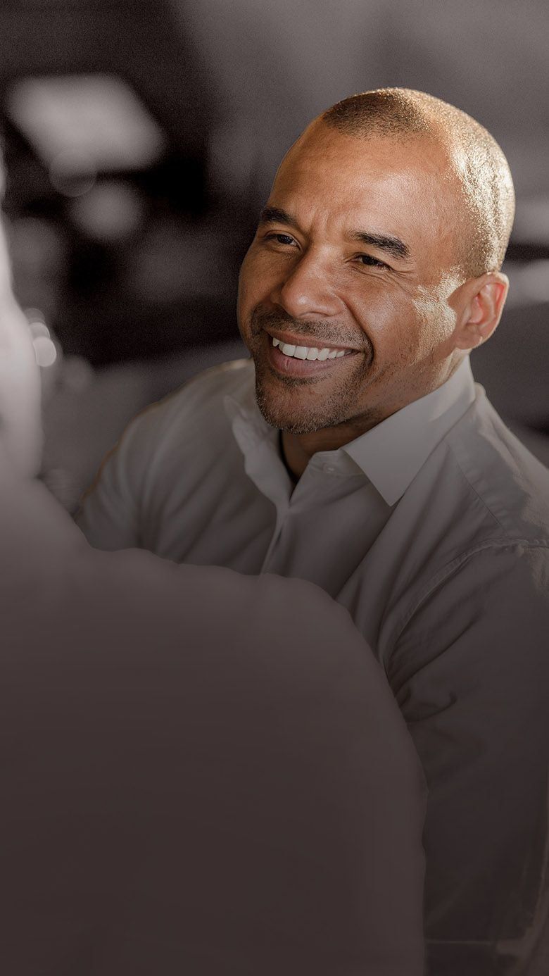 Portrait image of business professionals in conversation, representing leadership potential, talent identification, and succession readiness through RHR’s Succession Planning and Identifying Talent Solutions.