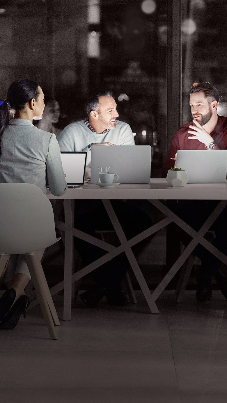 Portrait image of executive leaders collaborating during a meeting, representing executive alignment, strategic communication, and RHR’s Executive Leadership Team Solutions.