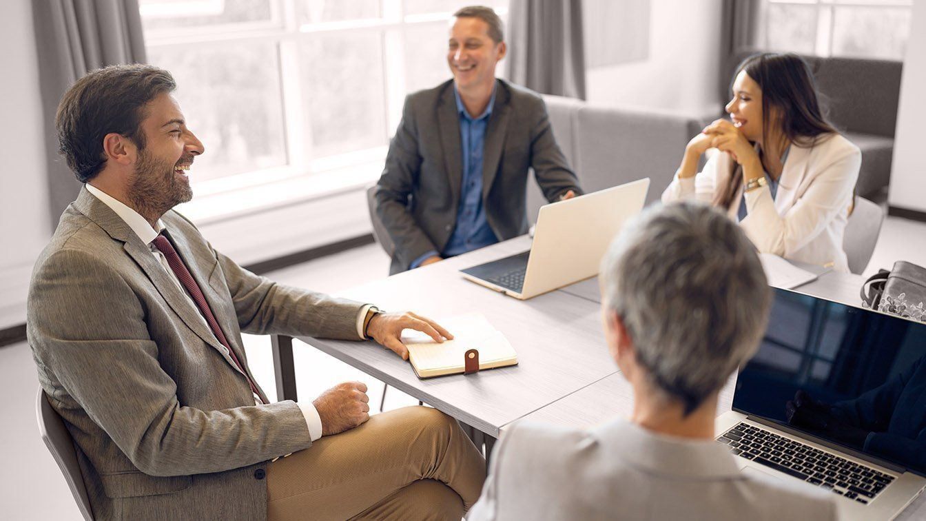 Landscape image of executive leaders collaborating during a meeting, representing executive alignment, strategic communication, and RHR’s Executive Leadership Team Solutions.