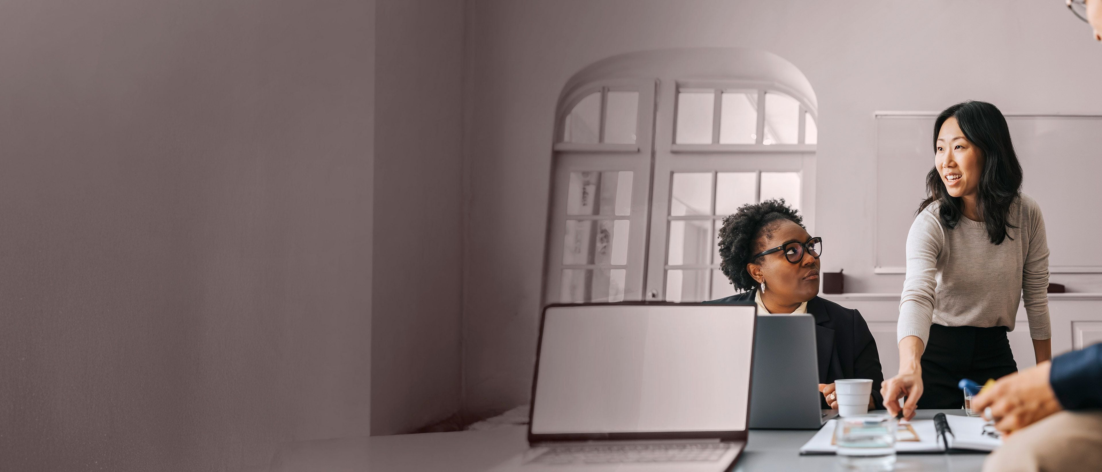 Diverse professionals collaborating in a meeting, representing the leaders, teams, and organizations RHR works with to strengthen leadership, improve team effectiveness, and drive meaningful business outcomes.
